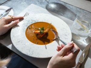 Guest enjoying Shrimp Bisque at Crown Grill House in Dubrovnik