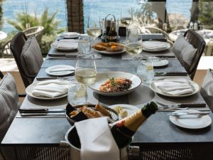 Elegant outdoor dining table at Royal Crown Grill House overlooking the Adriatic Sea