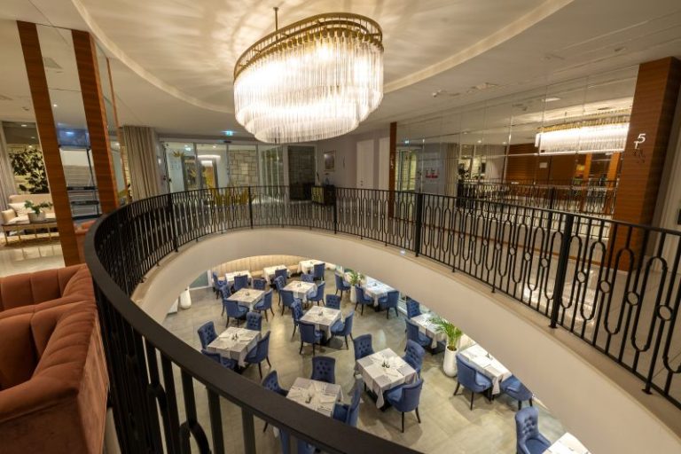 Elegant Vista Restaurant interior with curved dining area, grand chandelier and refined table settings in Dubrovnik